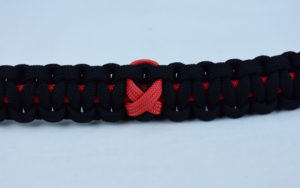 red and black heart disease support paracord bracelet with red ribbon in center
