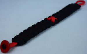 red and black heart disease support paracord bracelet with red button in the corner and red ribbon