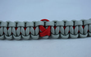 red and grey heart disease support paracord bracelet with red ribbon in the center
