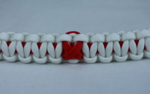 red and white heart disease support paracord bracelet with red ribbon center