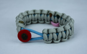 tarheel blue and grey sids support paracord bracelet with red button front and tarheel blue and pink ribbon