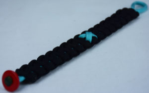 teal and black ptsd support paracord bracelet with red button in the bottom corner and teal ribbon