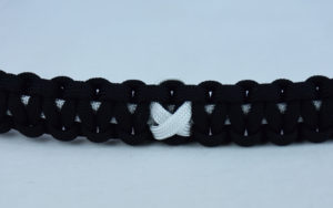 white and black multiple sclerosis support paracord bracelet with white ribbon center