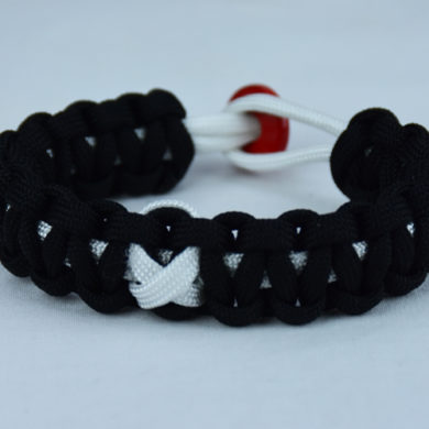 white and black multiple sclerosis support paracord bracelet with red button in back and white ribbon