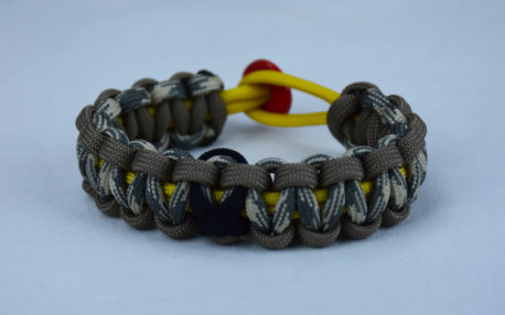yellow tan and desert sand foliage camouflage pow mia support paracord bracelet with red button back and black ribbon